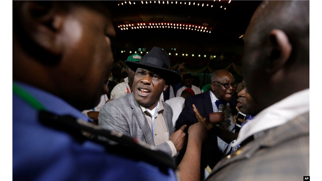 Peter Godsday Orubebea (C), Peoples Democratic Party agent, disrupts the announcing of election results in Abuja, Nigeria, March 31, 2015.