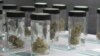 Vials filled with samples of marijuana line up March 24, 2017, at the Blum medical marijuana dispensary, in Reno, Nev. Sales of recreational marijuana began early July 1, 2017, across Nevada.