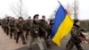 Ukrainian servicemen march away, after negotiations with Russian troops at the Belbek Sevastopol International Airport in the Crimea region, March 4, 2014. 