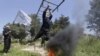 Rebel fighters from 'the First Regiment', part of the Free Syrian Army, swing from bars as they participate in a military training in the western countryside of Aleppo May 4, 2015. REUTERS/Hosam Katan