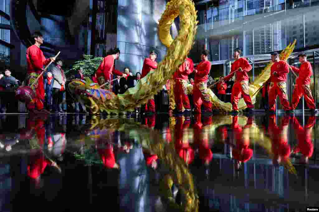 Dragon dancers perform in the Shanghai Tower building in the Pudong financial district after Lunar New Year holiday in Shanghai, China.