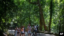Visitors stroll and pedal at the Tijuca National Park in Rio de Janeiro, Feb. 28, 2021. 
