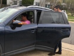 Ride-hailing driver Percy Saloman, picking up a fare in Northern Virginia on March 17, 2020, is driving longer hours for less money.