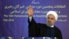 In this photo released by official website of the office of the Iranian Presidency, President Hassan Rouhani waves to media after casting his vote for parliamentary and Experts Assembly elections in Tehran, Iran Friday, Feb. 26, 2016.