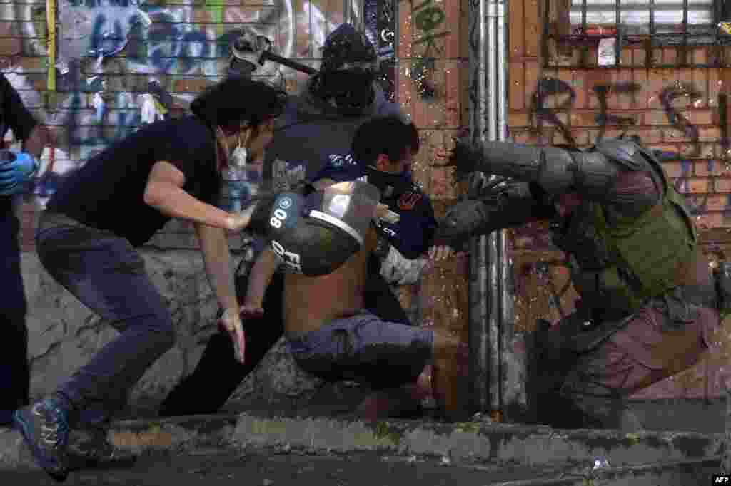Demonstrators clash with riot police during a protest against the government in Santiago, Chile, Nov. 16, 2019.