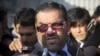 Anas al-Abdeh, center, a member of the Syrian National Coalition, Syria's main political opposition group, is surrounded by journalists after a meeting with a delegation of the Syrian government at the United Nations headquarters in Geneva, Switzerland, 