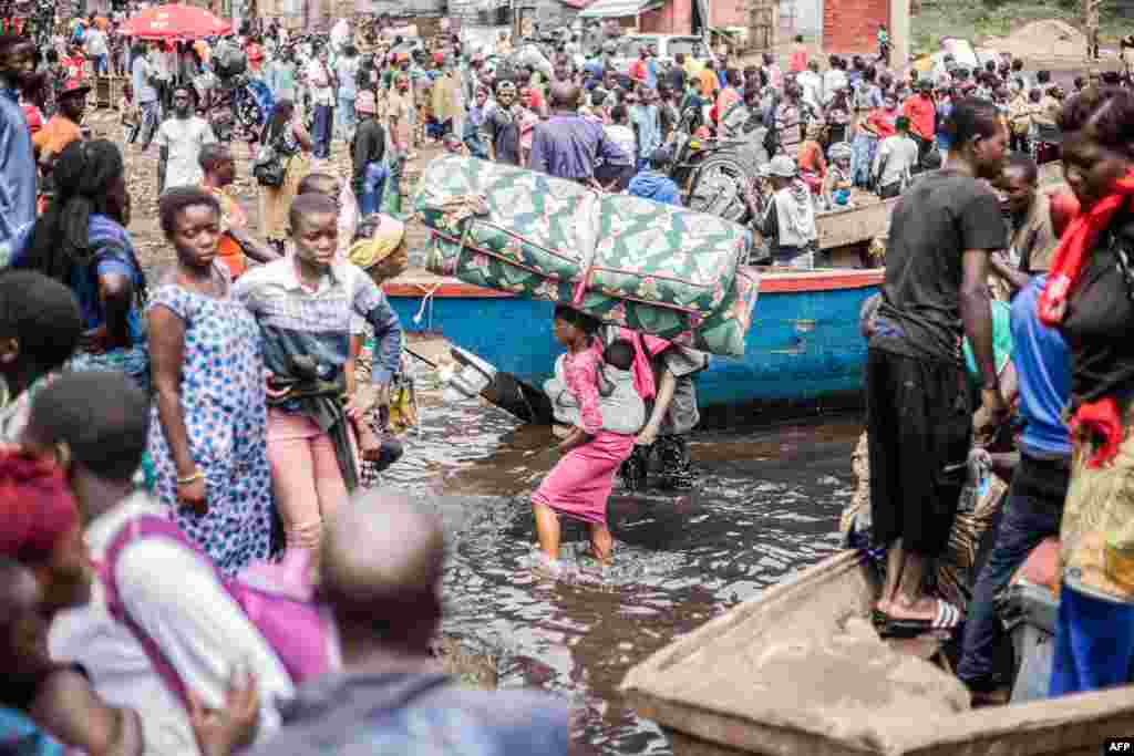 Displaced Congolese who fled the area of Minova leave the port of Nzulo to seek shelter in Goma, Democratic Republic of Congo. The Congolese army said that M23 fighters had made a "breakthrough" in the east of the country after the armed group seized Minova, a trading hub that supplies the city of Goma.