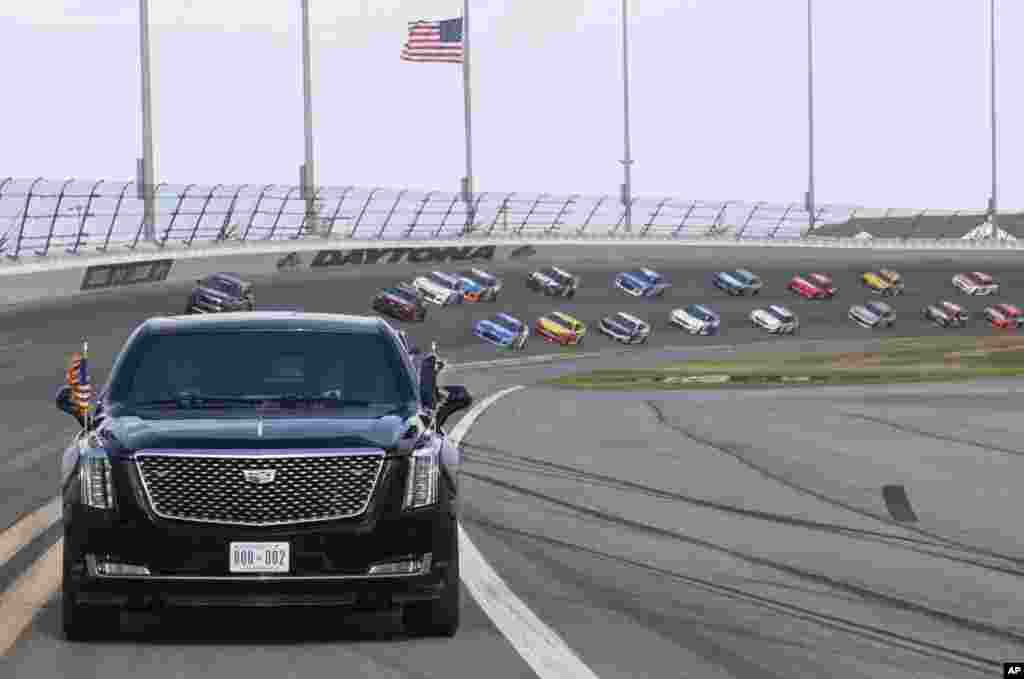 President Donald Trump and First Lady Melania Trump ride in the presidential limousine as they take a pace lap ahead of the start of the NASCAR Daytona 500 auto race at Daytona International Speedway in Daytona Beach, Florida, Feb. 16, 2020.