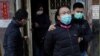 District councillor and lawyer Daniel Wong Kwok-tung, center, is escorted by police outside his office in Hong Kong, Jan. 14, 2021.