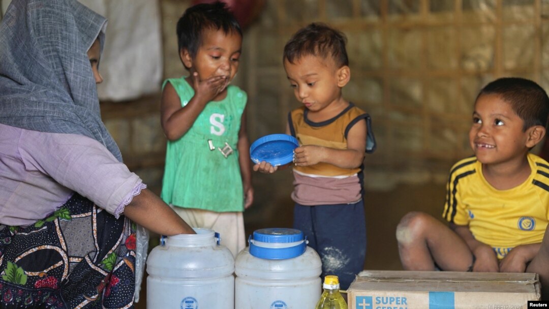 Rohingya children eat from jars with the USAID logo on them, at a refugee camp in Cox's Bazar, Bangladesh, Feb. 11, 2025.
