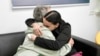 In this photo released by the Israeli Army, Emily Damari, right, and her mother Mandy near kibbutz Reim, southern Israel after Emily was released from captivity by Hamas militants in Gaza, Jan. 19, 2025. 