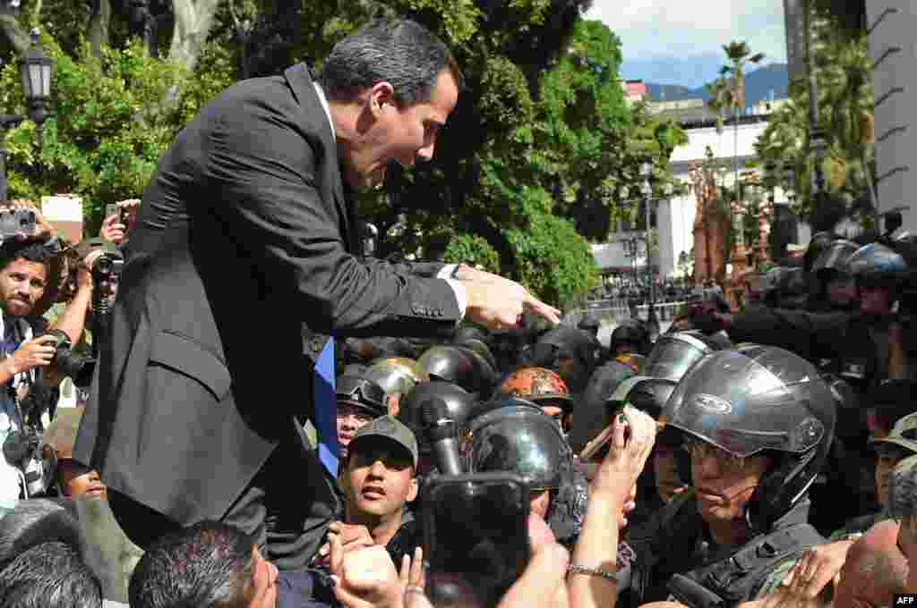 Venezuelan opposition leader and self-proclaimed acting president Juan Guaido confronts Bolivarian National Guard members upon arrival at the National Assembly, in Caracas.