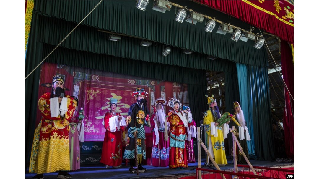 The wings are to the right and left of the stage. The audience can't see performers waiting in the wings. Here, Chiu Chow Opera performers sing on stage as part of the Hungry Ghost Festival in Hong Kong.