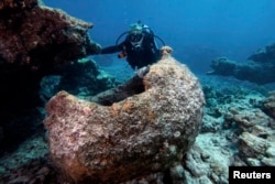 FILE - Maritime archaeologist Kelly Gleason with the Papahanaumokuakea Marine National Monument.