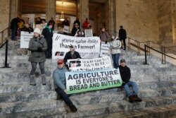 Farmers and other supporters hold signs Jan. 13, 2020, at the Capitol in Olympia, Wash., during a day to raise awareness of issues facing farmers in Washington state on the first day of the 2020 session of the Washington legislature.