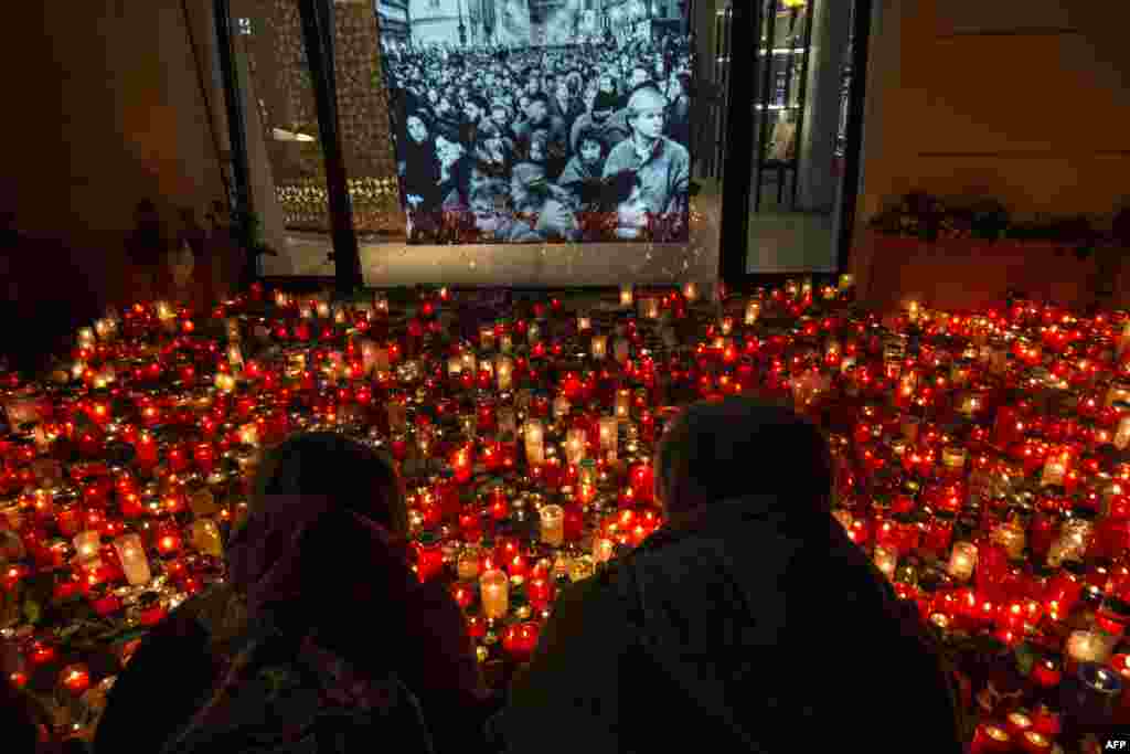 People place candles at a memorial to commemorate the 30th anniversary of the so-called Velvet Revolution in Prague, Czech Republic. The peaceful Velvet Revolution toppled the Communist regime in former Czechoslovakia 30 years ago, paving the way for democratic and economic reforms in the former Soviet satellite.