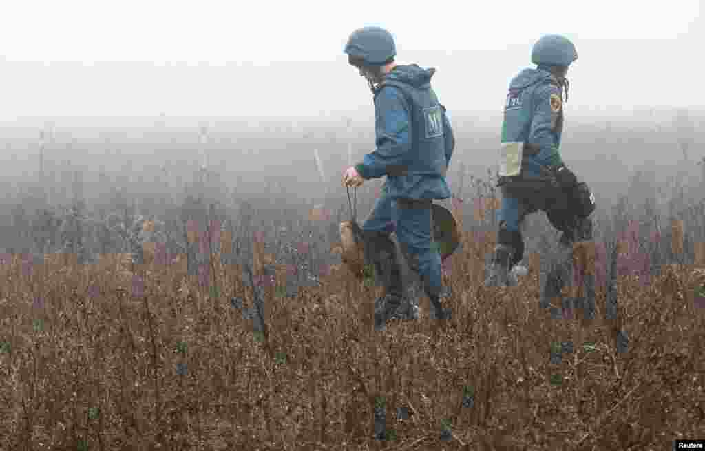 Members of the Emergencies Ministry of the separatist Donetsk People's Republic demine the area near the settlement of Petrovskoye (Petrivske) in Donetsk region, Ukraine, Nov. 19, 2019.