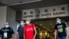 FILE - Koo Sze-yiu (in red) leaves following a court hearing in Hong Kong, Sept. 30, 2020 (Tommy Walker/VOA)
