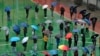 FILE - Residents line up to get tested for the coronavirus at a temporary testing center despite the rain in Hong Kong, Feb. 22, 2022.