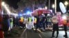 Police officers, firefighters and rescue workers are seen at the site of an attack on July 15, 2016, after a truck drove into a crowd watching a fireworks display in the French Riviera town of Nice.