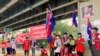 FILE - Anti-coup protesters hold a banner that reads “Karen National Group! Don’t want military dictatorship,” during a silent protest outside the Hledan Centre in Yangon, Myanmar, Feb. 21, 2021. 