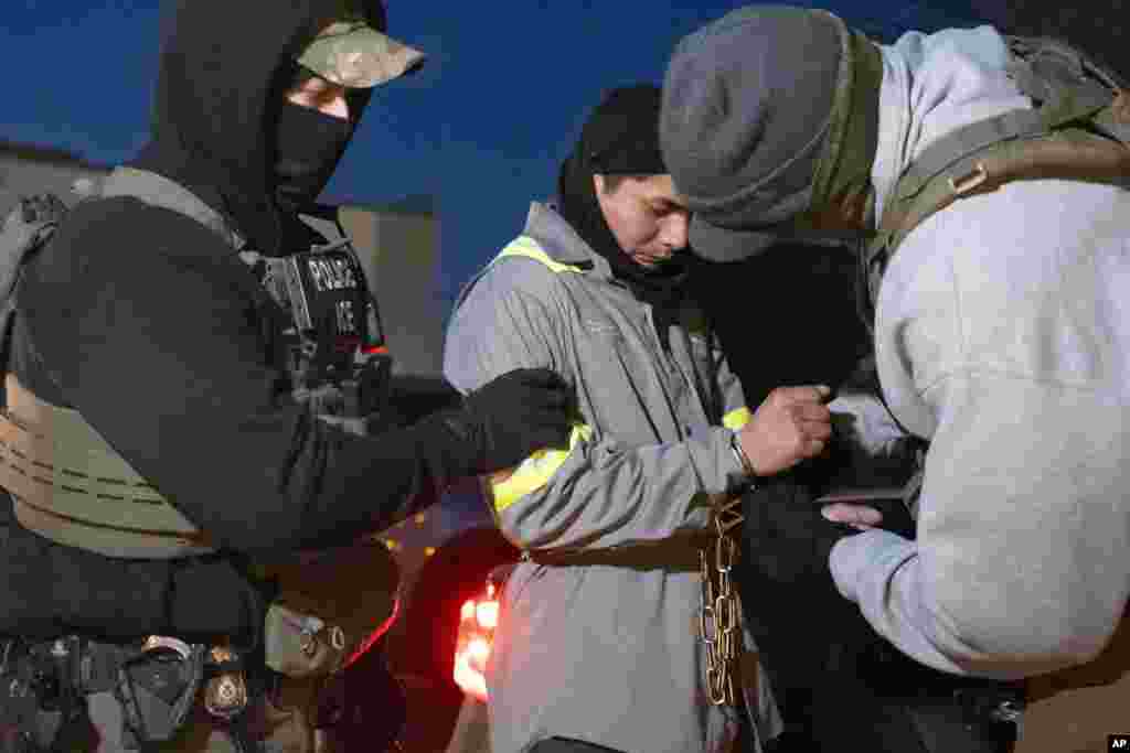 U.S. Immigration and Customs Enforcement officers detain a person in Silver Spring, Maryland on January 27, 2025.