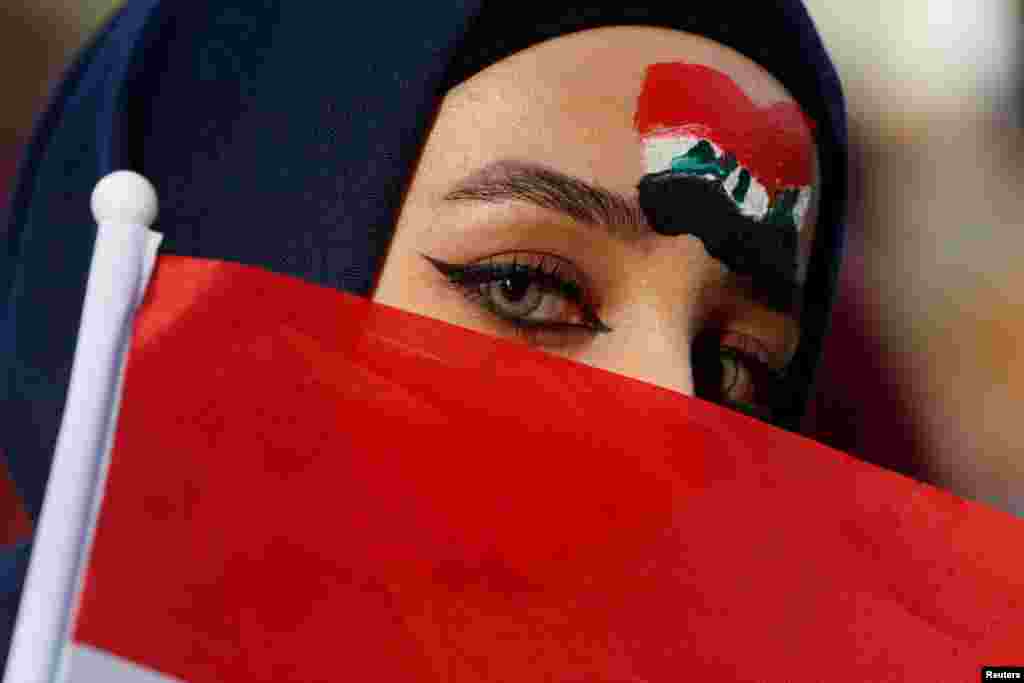 An Iraq fan poses before the World Cup 2022 Qualifier 2nd round Group C football match between Iraq and Iran at Amman International Stadium in Amman, Jordan.