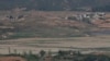 North Korea's Kaepoong town is seen behind a North Korean military guard post, bottom, from the unification observatory in Paju, South Korea, May 6, 2019. North Korea says it is suffering its worst drought in decades amid concern of a food crisis..