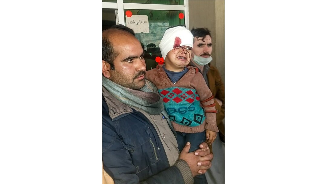A Pakistani Kashmiri carries an injured child at a hospital following cross-border shelling between Pakistani and Indian forces in Tehjain village at the Line of Control in Neelum Valley, Pakistan-administered Kashmir, Nov. 13, 2020.