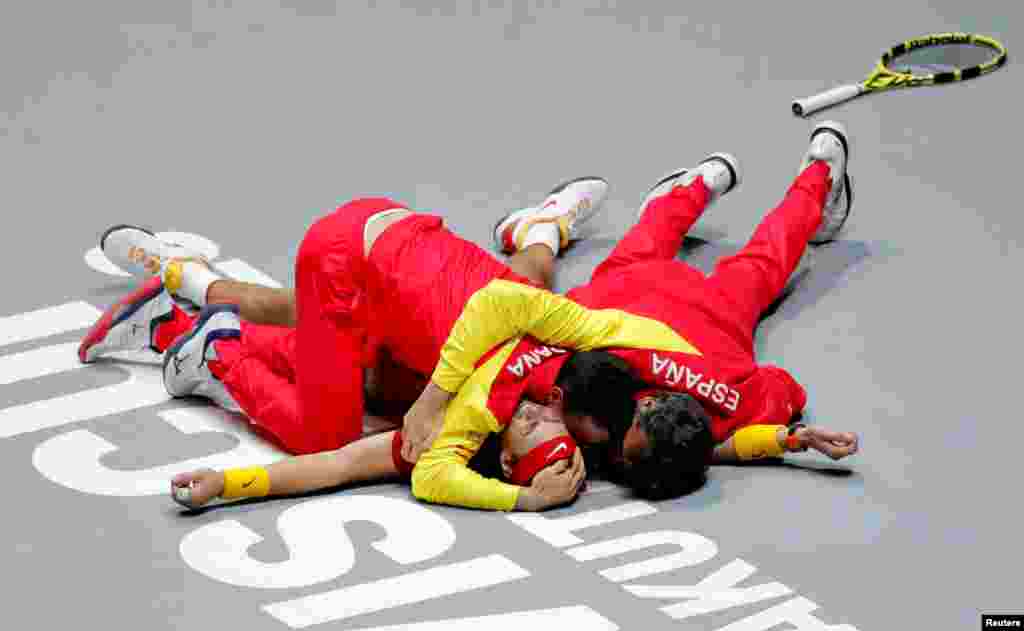 Spain's Rafael Nadal celebrates with the team after winning his match against Canada's Denis Shapovalov and winning the Davis Cup Finals in Madrid, Spain, Nov. 24, 2019.