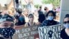 Archawee Dhamavasi (right), a 43-year-old Thai-American mother goes to a Black Lives Matter protest with her daugther, Natasha Dhamvasi (second from left), in Downers Grove village, Illinois on June 7, 2020
