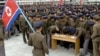 15일 북한의 비공개 장소에서 젊은 청년들이 군 입대 및 복귀 신청서에 서명하는 모습을 북한 관영매체 조선중앙통신이 보도했다.
