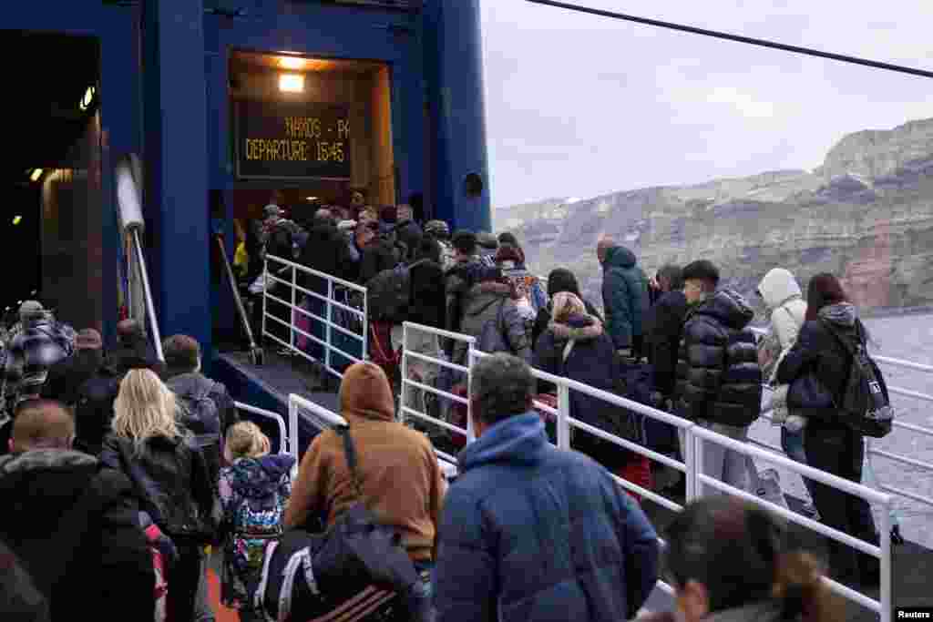 People board a ferry to Piraeus during increased seismic activity on the island of Santorini, Greece.
