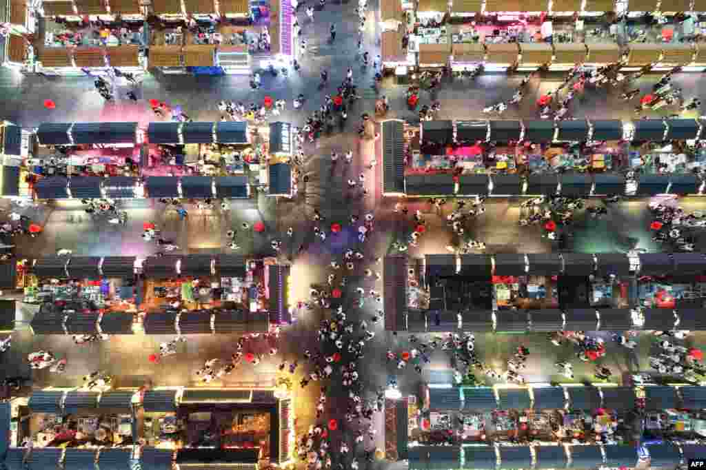 This aerial photo shows people visiting a night market in Shenyang in China's northeastern Liaoning province, June 16, 2020.