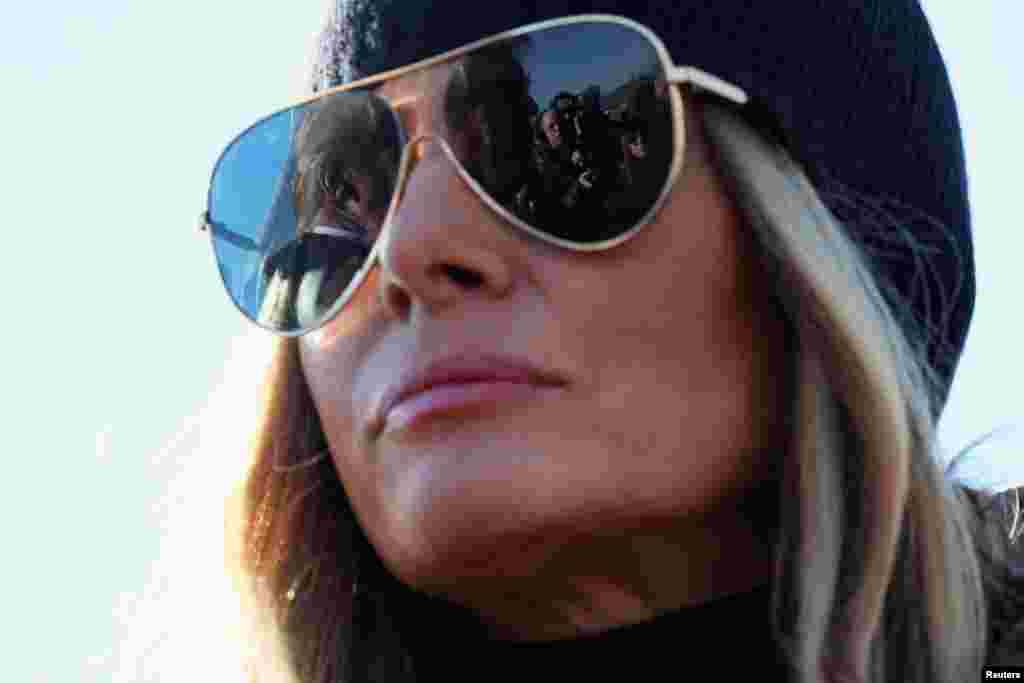 U.S. President Donald Trump is reflected in first lady Melania Trump's sunglasses as he speaks to the media, as they arrive to assess recovery efforts and tour areas devastated by Hurricane Helene, in Asheville, North Carolina. REUTERS/Leah Millis