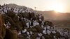 Muslim pilgrims pray on a rocky hill known as Mountain of Mercy, on the Plain of Arafat, during the annual hajj pilgrimage, ahead of sunrise near the holy city of Mecca, Saudi Arabia, Sept. 11, 2016.