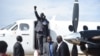 Second-in-command of South Sudan's rebels, Alfred Lado Gore, raises his fist after landing in the capital Juba, after more than two years in exile, April 12, 2016. Rebel leader Riek Machar is scheduled to return on April 18. 