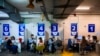 FILE - Israelis receive a Pfizer-BioNTech COVID-19 vaccine from medical professionals at a coronavirus vaccination center set up on a shopping mall parking lot in Givataim, Israel, Feb. 4, 2021.
