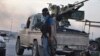 Fighters of the Islamic State of Iraq and the Levant (ISIL) stand guard at a checkpoint in the northern Iraq city of Mosul, June 11, 2014. 