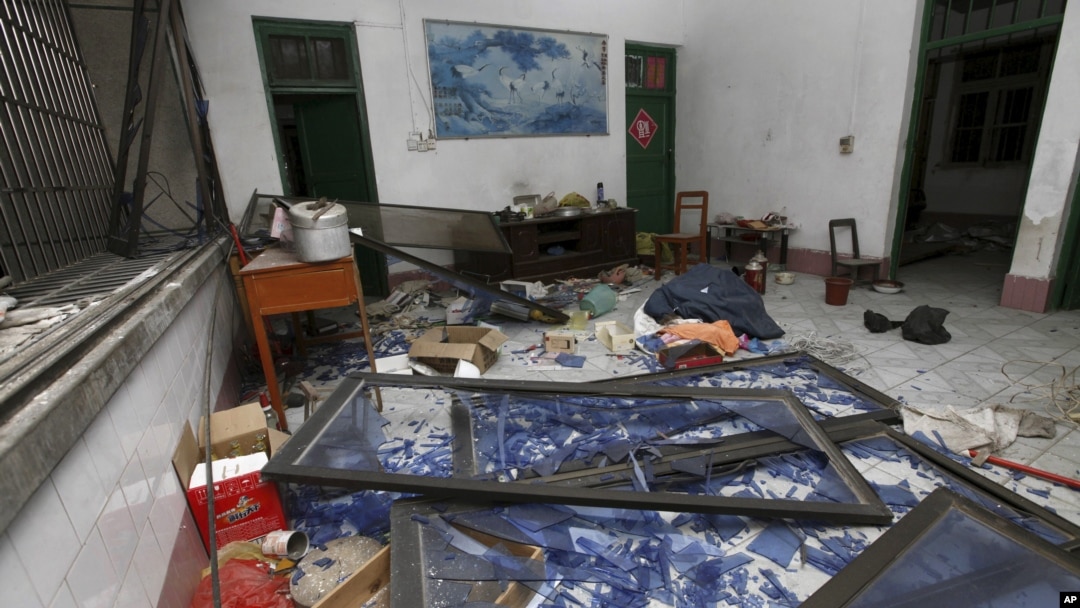 A damaged room in a residential building is seen after several locations were targeted with parcel bombs in the southwestern city of Liuzhou, Guangxi province, Sept. 30, 2015. (REUTERS/String)