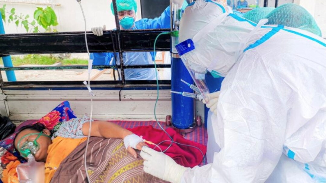 Volunteers treat a coronavirus (COVID-19) patient in the town of Kale