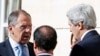 Russia's Foreign Minister Sergei Lavrov (L) and U.S. Secretary of State John Kerry (R) speak as French President Francois Hollande stands between them during a coffee break in the Meeting of the International Support Group for Lebanon at the Elysee Palace